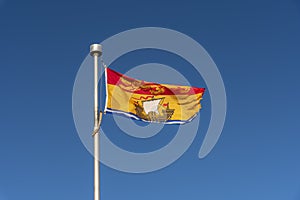 New Brunswick flag against blue sky