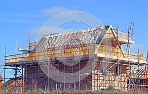New build house with roof rafters and scaffolding. photo