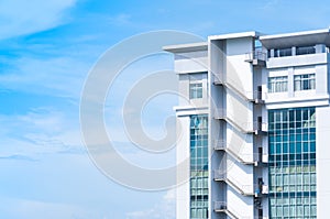 New building architecture with fire escape stairs on blue sky background