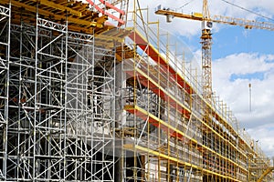 New building construction stite, scaffolding and crane on buldi