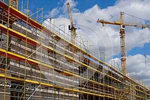 New building construction stite, scaffolding and crane on buldi photo