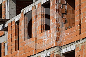 New building of a red brick multi-storey residential building. Background