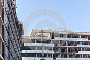 New building under construction against clean blue sky