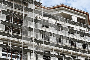 New building under construction, scaffolding and concrete
