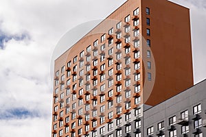 New buildings in Moscow, high-rise bright creative house and against the sky