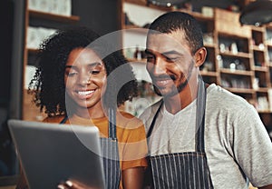 New business owners using tablet in cafe