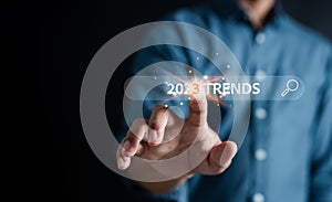 New business target start up in new years, Businessman using smartphone to input keyword of 2023 trends inside infographic