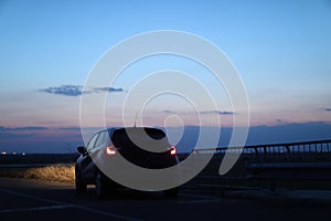 New car, close-up view at sunset
