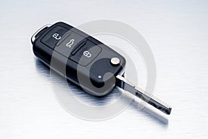 New car key fob on aluminium background. Repair of broken or damaged remote key fob of any vehicle car service concept.- Image