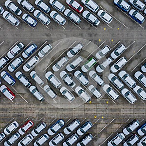 New car lined up aerial view. Port of import and export business logistic to dealership for sale. Automobile and automotive car