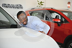 New Car Owner. Happy African American Man Touching Hugging His Brand-New Auto