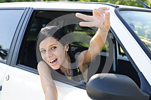 New car: teenage girl showing victory sign