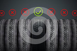 New car tire with green check mark standing out among old tires