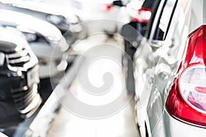 New cars at dealer showroom blurred background