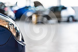 New cars at dealer showroom blurred background