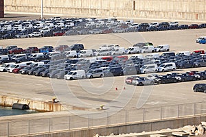 New cars in parking lot ready to be shipped. Vehicle production