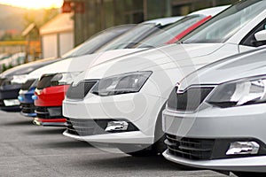 New cars for sale parked in front of a car, motor dealer store, shop