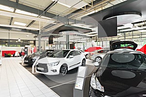 New cars in the sales area of a car dealership - building and ar