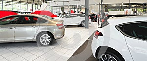 New cars in the sales area of a car dealership - building and ar