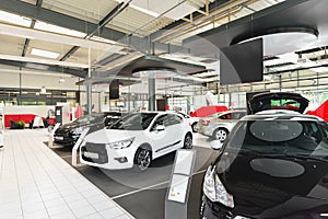 New cars in the sales area of a car dealership - building and ar photo