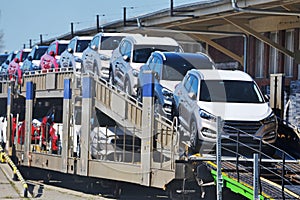 Transportation of new cars on railway platforms. photo