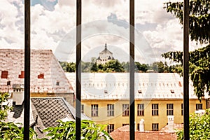 New castle behind a metal fence, Banska Stiavnica, yellow filter