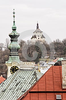 New castle and church tower with clock in Banska Stiavnica, Slov