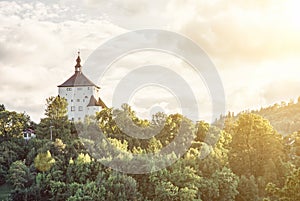 New Castle with forest with yellow sun rays, Banska Stiavnica