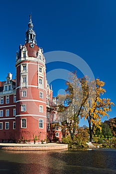 New Castle and moat in the park Muskauer  during autumn