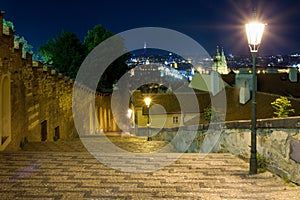 New castle stairs road leading up to Prague Castle Czech Republic enlightened by street lamps with a beautiful view over Prague