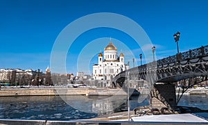 The new Cathedral of Christ the Saviour and the Patriarchy pedestrian bridge over the Moscow River in Moscow. Russia.