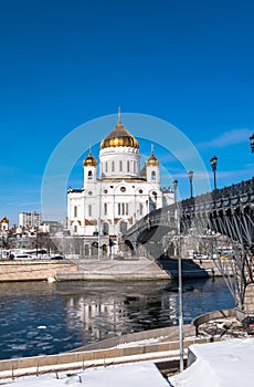 The new Cathedral of Christ the Saviour and the Patriarchy pedestrian bridge over the Moscow River in Moscow. Russia.