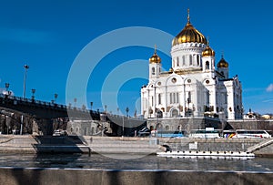 The new Cathedral of Christ the Saviour and the Patriarchy pedestrian bridge over the Moscow River in Moscow. Russia.