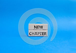 New Chapter symbol. Concept word New Chapter on wooden blocks. Beautiful blue background. Business and New Chapter concept. Copy