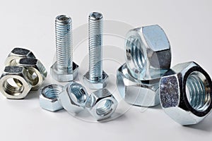 New chrome screw-nut of different sizes on a white background. Concept