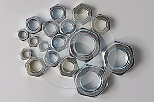 New chrome screw-nut of different sizes on a white background. Concept