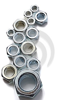 New chrome screw-nut of different sizes on a white background. Concept.