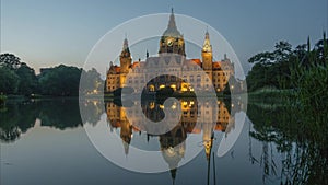 New City Hall of Hannover reflecting in water in the evening. Time lapse.