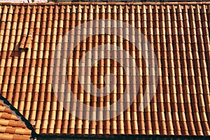 New clean brown tiles on the roof of the building.