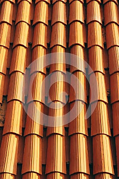 New clean brown tiles on the roof of the building.