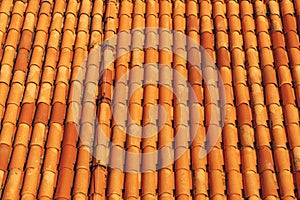 New clean brown tiles on the roof of the building.