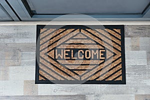 New clean mat with word WELCOME near door, top view