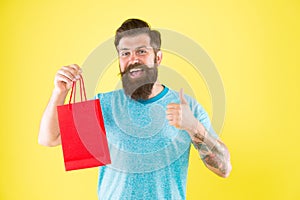 New collection. happy hipster hold paperbag. Man with gift package. Buy product. little pleasantness. bearded man go