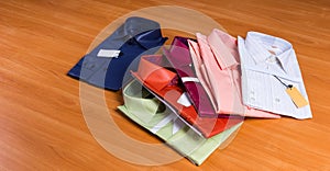 New Colorful Dress Shirts Fanned on Wooden Surface