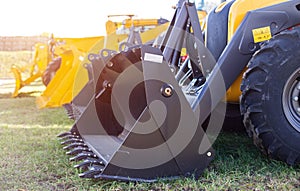 New construction equipment, wheel loaders with bucket for loading sand trucks, transportation