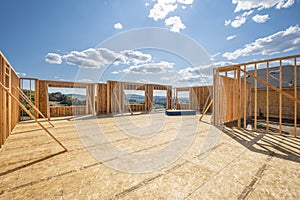 A new construction home framed with no roof or walls at a hilltop upscale subdivision