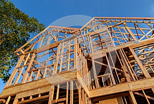 New construction home framing against a blue sky