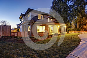 New construction home with low slope roof and brown siding.