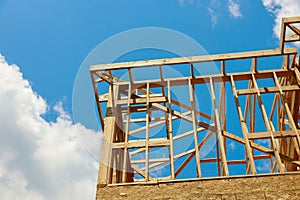 New construction home residential construction home framing against a blue sky