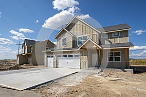 A new construction home still under construction, with a 3 car garage goes up in a Spokane, Washington